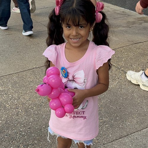 A young girl with her balloon poodle, Labor Day weekend 2026