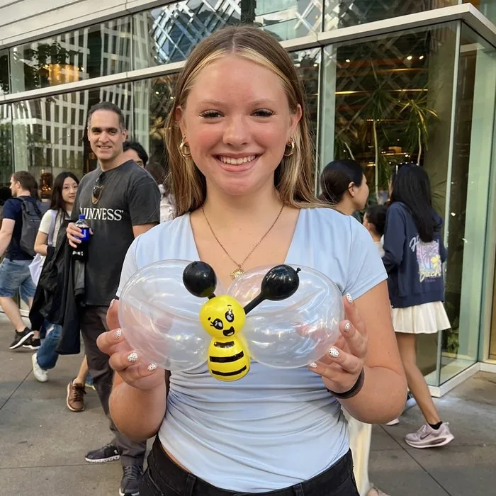 A young girl with her balloon bee, Labor Day weekend 2026