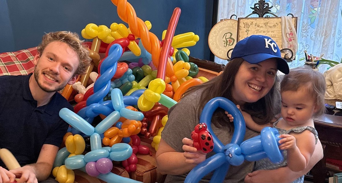 Michael Romani twisting balloons for a child and mom at a daycare near Portage Park, August 2026
