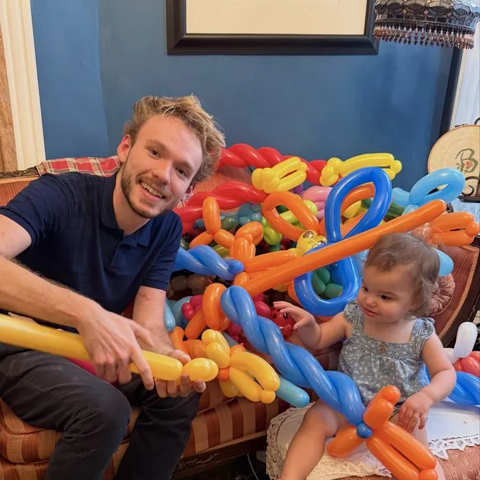 Michael Romani twisting balloons at a daycare near Portage Park