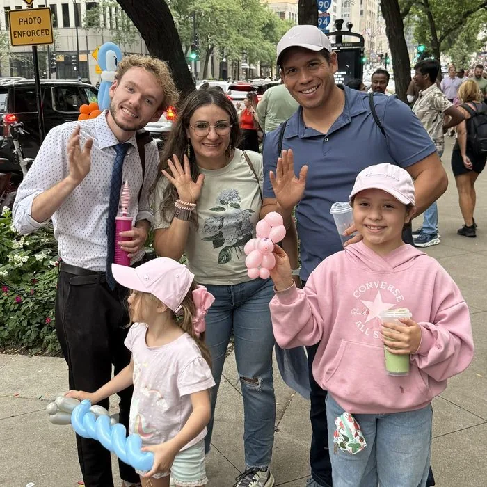 Michael Romani with a family on Michigan Avenue, Labor Day weekend 2026