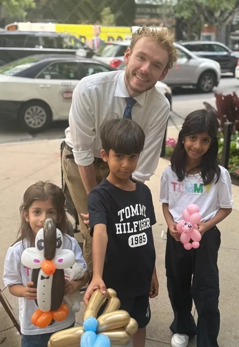 Michael Romani with three siblings on Michigan Avenue, mid-August 2026